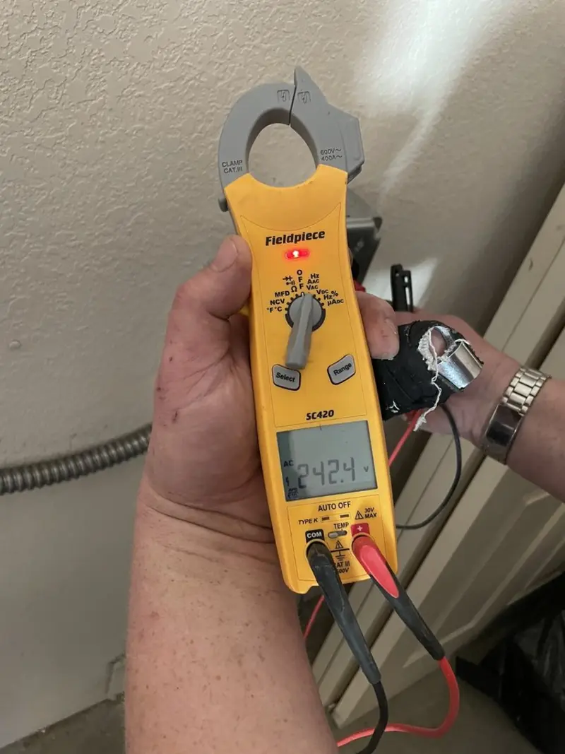 Voltage testing with clamp meter during Outlet Installation in Watseka
